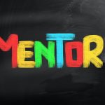 The word "Mentor" written in different colored chalk on a chalk board